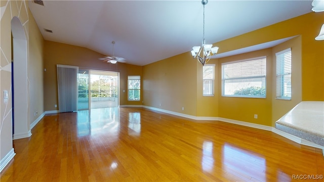 unfurnished room with wood-type flooring, ceiling fan with notable chandelier, and lofted ceiling