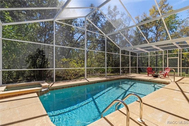 view of pool with a patio, a lanai, and a pool with connected hot tub