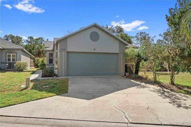 single story home featuring stucco siding, a front lawn, an attached garage, and driveway