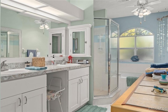 bathroom featuring a sink, a ceiling fan, and a shower stall