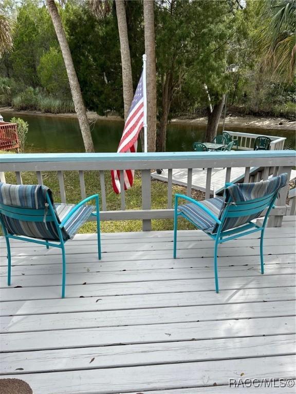 wooden terrace featuring a water view