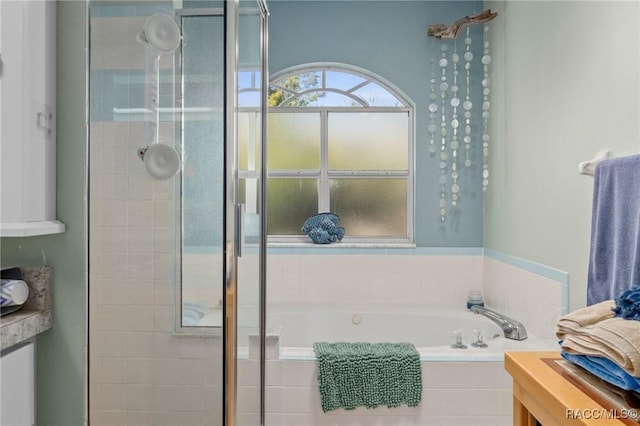 full bathroom with a garden tub and a stall shower