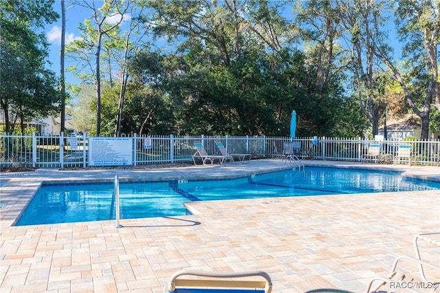 view of swimming pool featuring a patio area