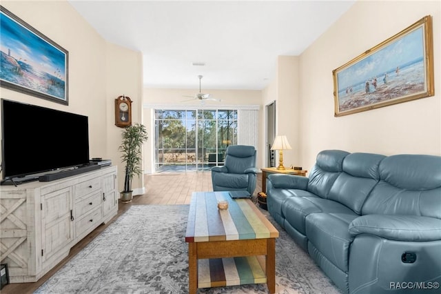 living room featuring ceiling fan and light wood-type flooring