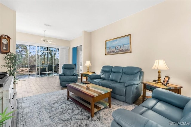 living room with ceiling fan and light hardwood / wood-style floors