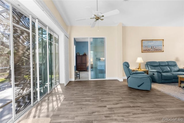 living room with lofted ceiling, hardwood / wood-style floors, and ceiling fan