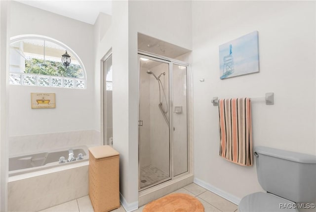 bathroom featuring tile patterned floors, toilet, and separate shower and tub