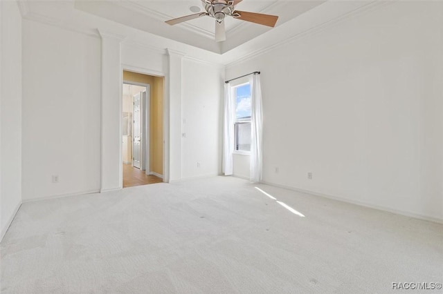 carpeted empty room featuring ceiling fan and ornamental molding