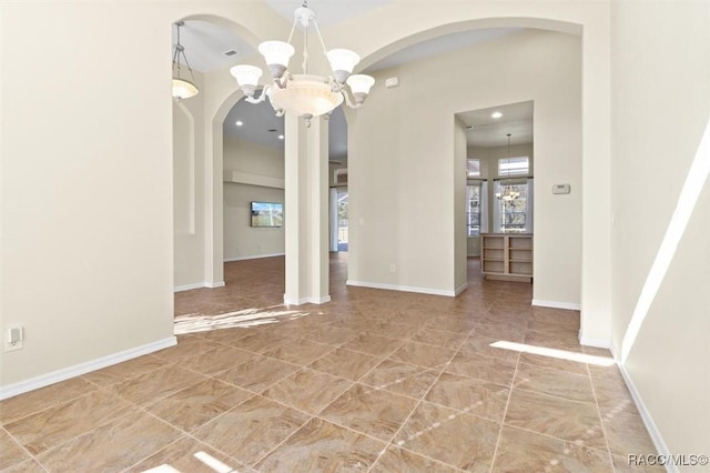 unfurnished dining area featuring a chandelier