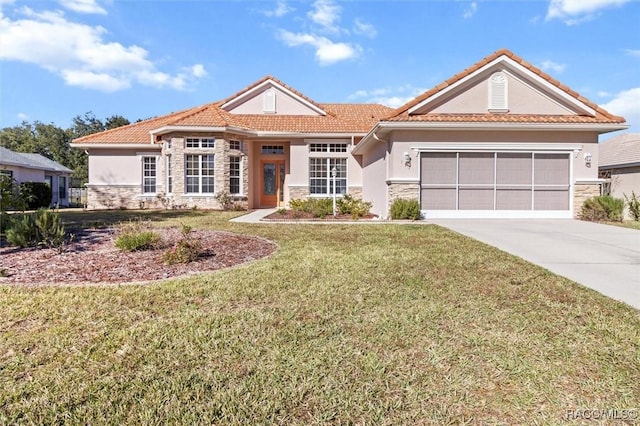 mediterranean / spanish-style home with a front yard and a garage