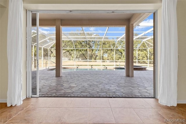 doorway featuring plenty of natural light and light tile patterned floors