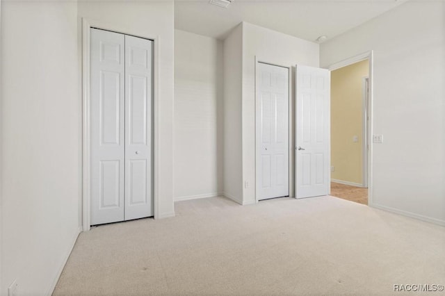 unfurnished bedroom featuring light colored carpet