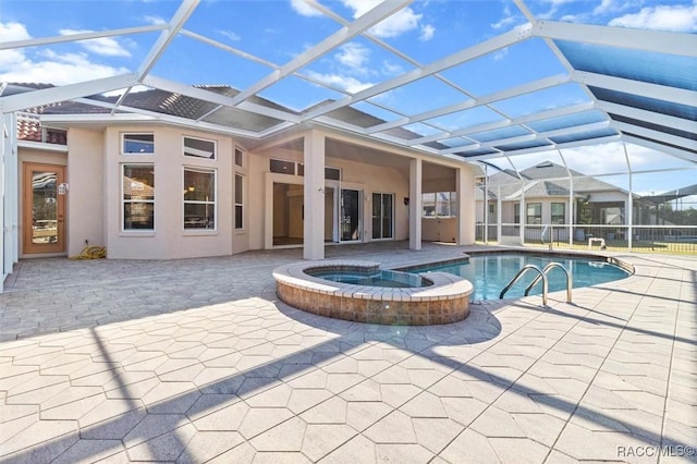 view of swimming pool with an in ground hot tub, a patio, and a lanai