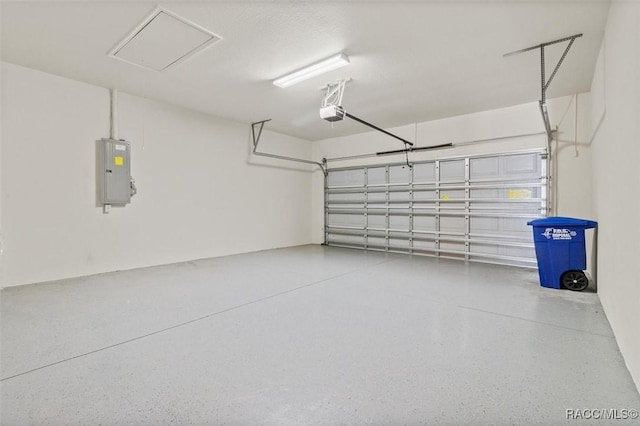 garage featuring electric panel and a garage door opener