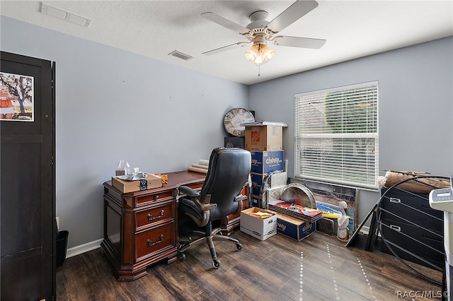 home office with a textured ceiling, dark hardwood / wood-style floors, and ceiling fan