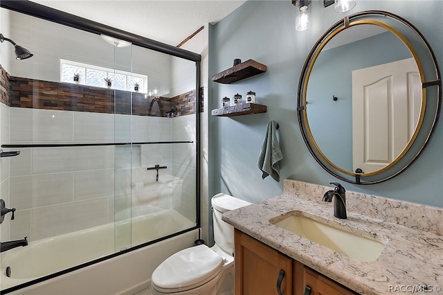 full bathroom with combined bath / shower with glass door, vanity, and toilet