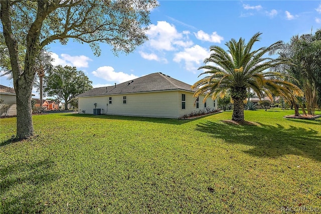 exterior space with a lawn and central air condition unit