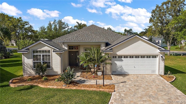 single story home with a garage and a front lawn