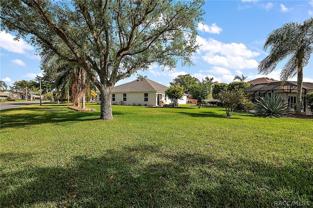 view of yard with a lanai