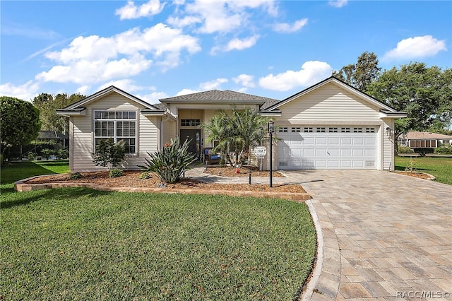 view of front of house with a garage and a front yard