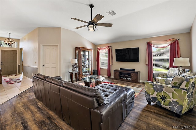 living room with hardwood / wood-style floors, ceiling fan, and lofted ceiling