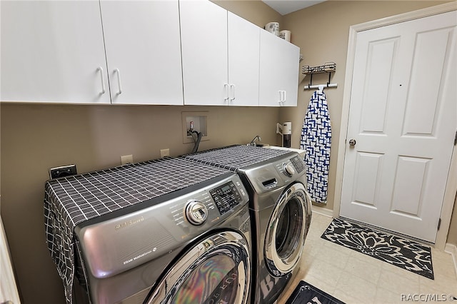 washroom with cabinets and independent washer and dryer