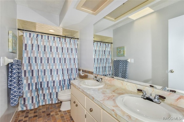 bathroom with vanity, curtained shower, and toilet