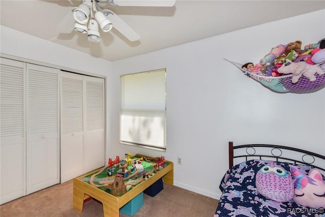 bedroom with ceiling fan, carpet, and a closet