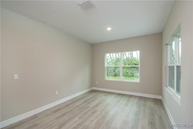 unfurnished room with light hardwood / wood-style flooring