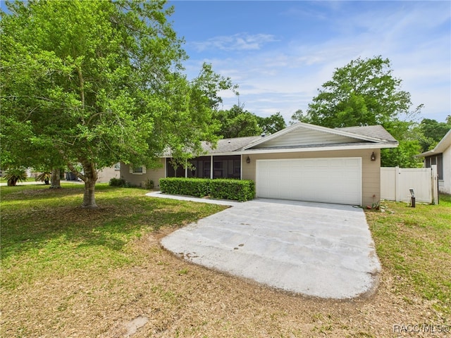 ranch-style home featuring concrete driveway and a garage