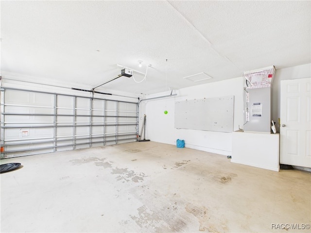 garage featuring a garage door opener and heating unit
