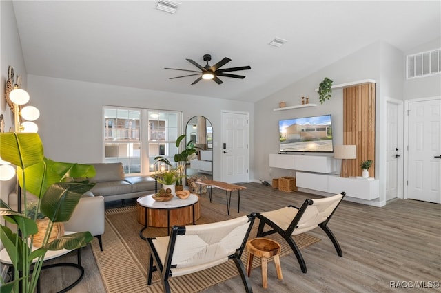 living room featuring ceiling fan, lofted ceiling, and hardwood / wood-style flooring