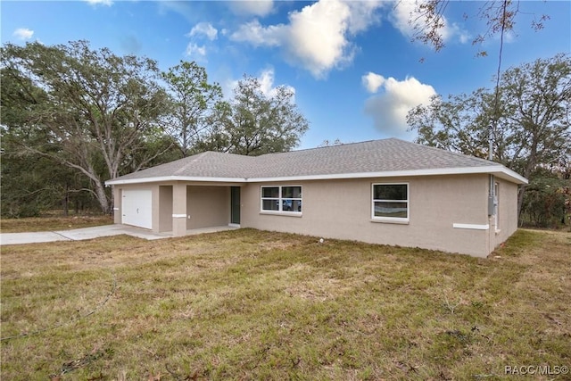 exterior space featuring a front lawn and a garage