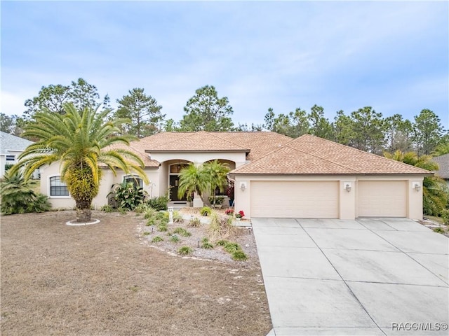 mediterranean / spanish-style home with a garage