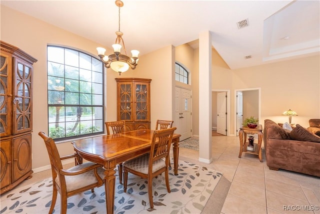 dining space featuring vaulted ceiling, light tile patterned flooring, and a notable chandelier