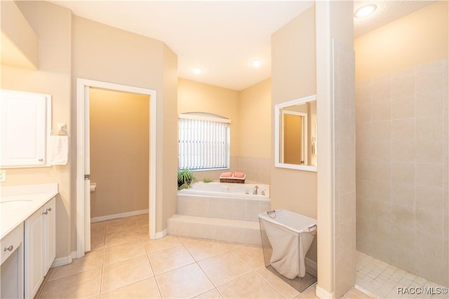 bathroom featuring tile patterned flooring, vanity, and independent shower and bath