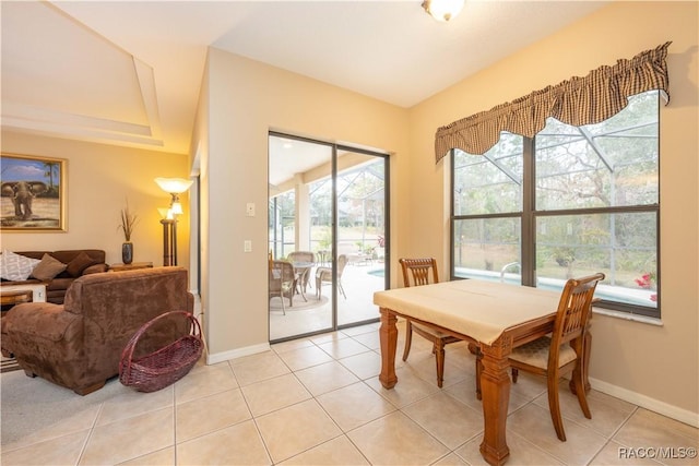 dining area with light tile patterned flooring and a healthy amount of sunlight