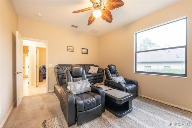 home theater featuring light carpet and ceiling fan