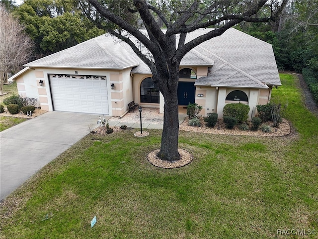 ranch-style house featuring a garage and a front lawn