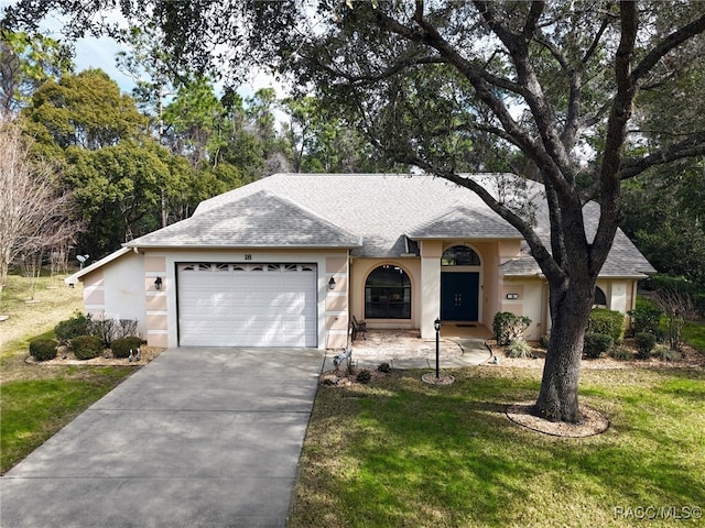 ranch-style home with a garage and a front yard