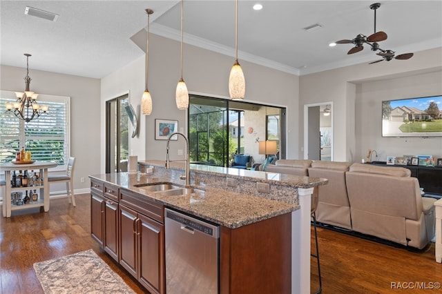 kitchen with sink, light stone counters, stainless steel dishwasher, a breakfast bar, and a center island with sink