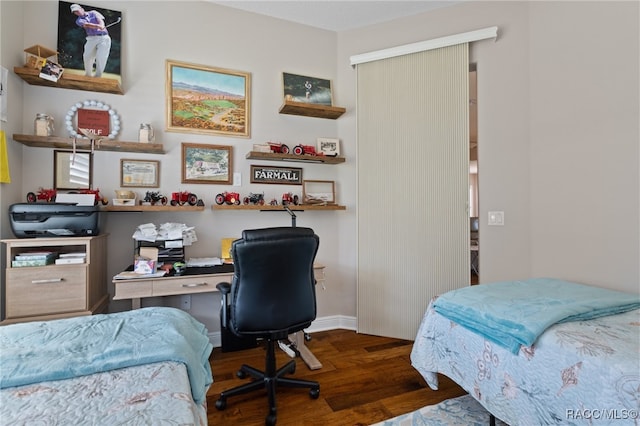 bedroom with dark hardwood / wood-style flooring