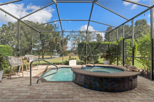 view of swimming pool featuring an in ground hot tub, glass enclosure, and a patio area