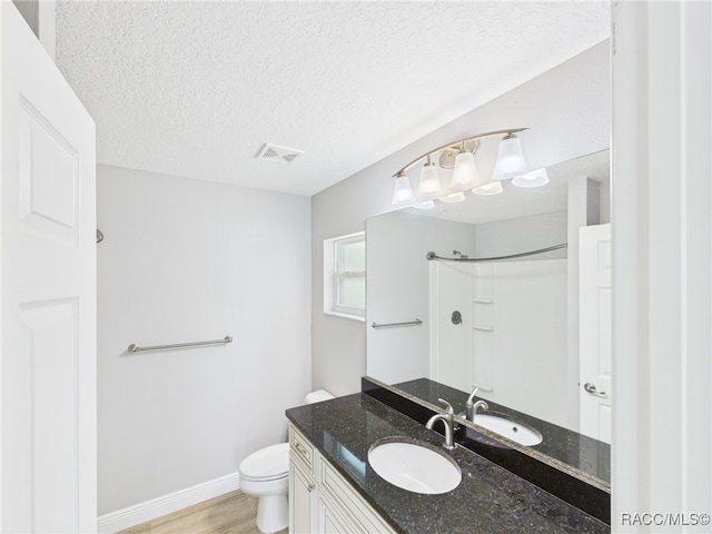1899 W Oliver Dr, Citrus Springs, FL 34434 - full bath with vanity, a shower, a textured ceiling, and wood finished floors