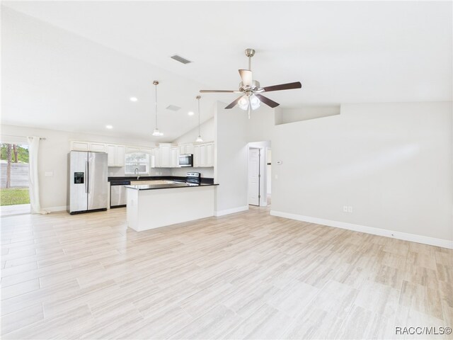 1899 W Oliver Dr, Citrus Springs, FL 34434 - kitchen with appliances with stainless steel finishes, open floor plan, a ceiling fan, white cabinetry, and dark countertops
