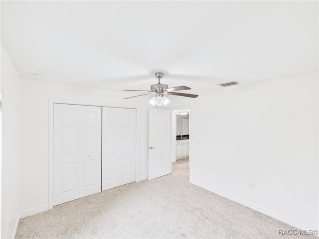 1899 W Oliver Dr, Citrus Springs, FL 34434 - unfurnished bedroom with light carpet, a closet, and a ceiling fan