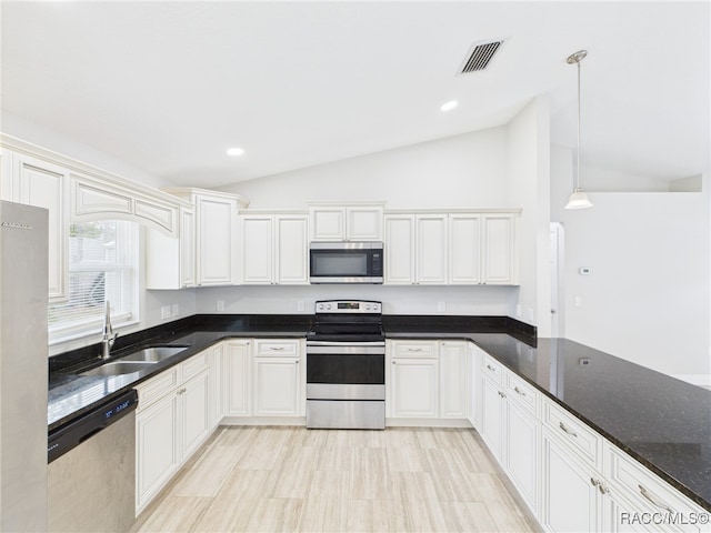 1899 W Oliver Dr, Citrus Springs, FL 34434 - kitchen with stainless steel appliances, lofted ceiling, pendant lighting, dark stone counters, and recessed lighting