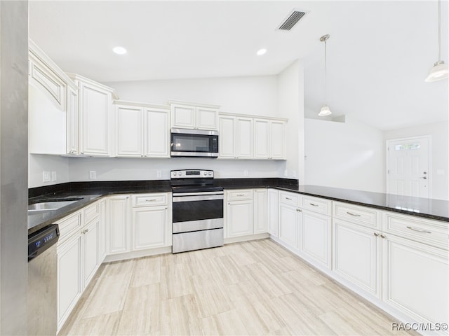 1899 W Oliver Dr, Citrus Springs, FL 34434 - kitchen with stainless steel appliances, vaulted ceiling, hanging light fixtures, and recessed lighting