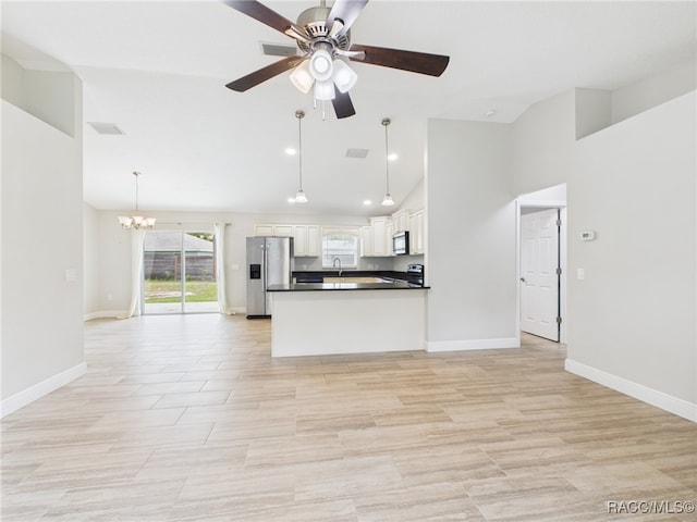 1899 W Oliver Dr, Citrus Springs, FL 34434 - kitchen featuring appliances with stainless steel finishes, open floor plan, dark countertops, a chandelier, and high vaulted ceiling