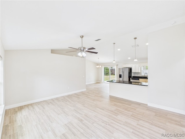 1899 W Oliver Dr, Citrus Springs, FL 34434 - unfurnished living room featuring ceiling fan, a chandelier, light wood-style flooring, and lofted ceiling